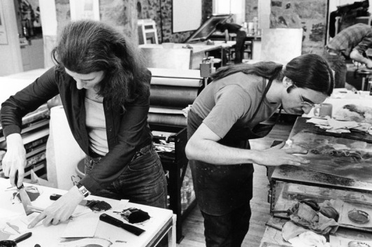 Nancy Graves mixes inks while Rodney Konopaki wipes copper intaglio plate in preparation for printing an impression, Tyler Graphics Ltd. workshop, Bedford Village, New York, 1977