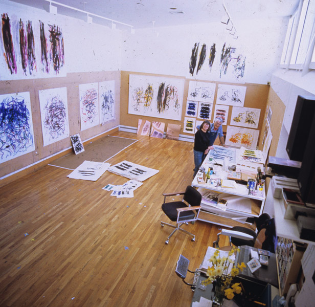 Joan Mitchell and Kenneth Tyler surrounded by numerous prints by Mitchell