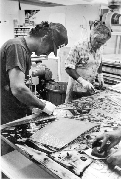 Frank Stella and Kenneth Tyler inking relief sections of a 'Swan engraving' plate and wiping the plate with scraps of newsprint, Tyler Graphics Ltd., Bedford Village, New York, 1981